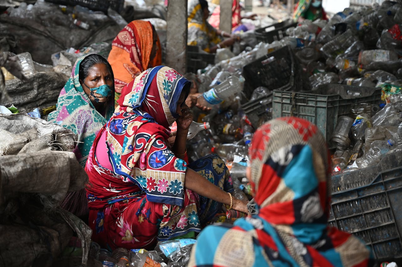 about-01 Women recycling plastic bottles in Chattogram, Bangladesh, promoting sustainability.