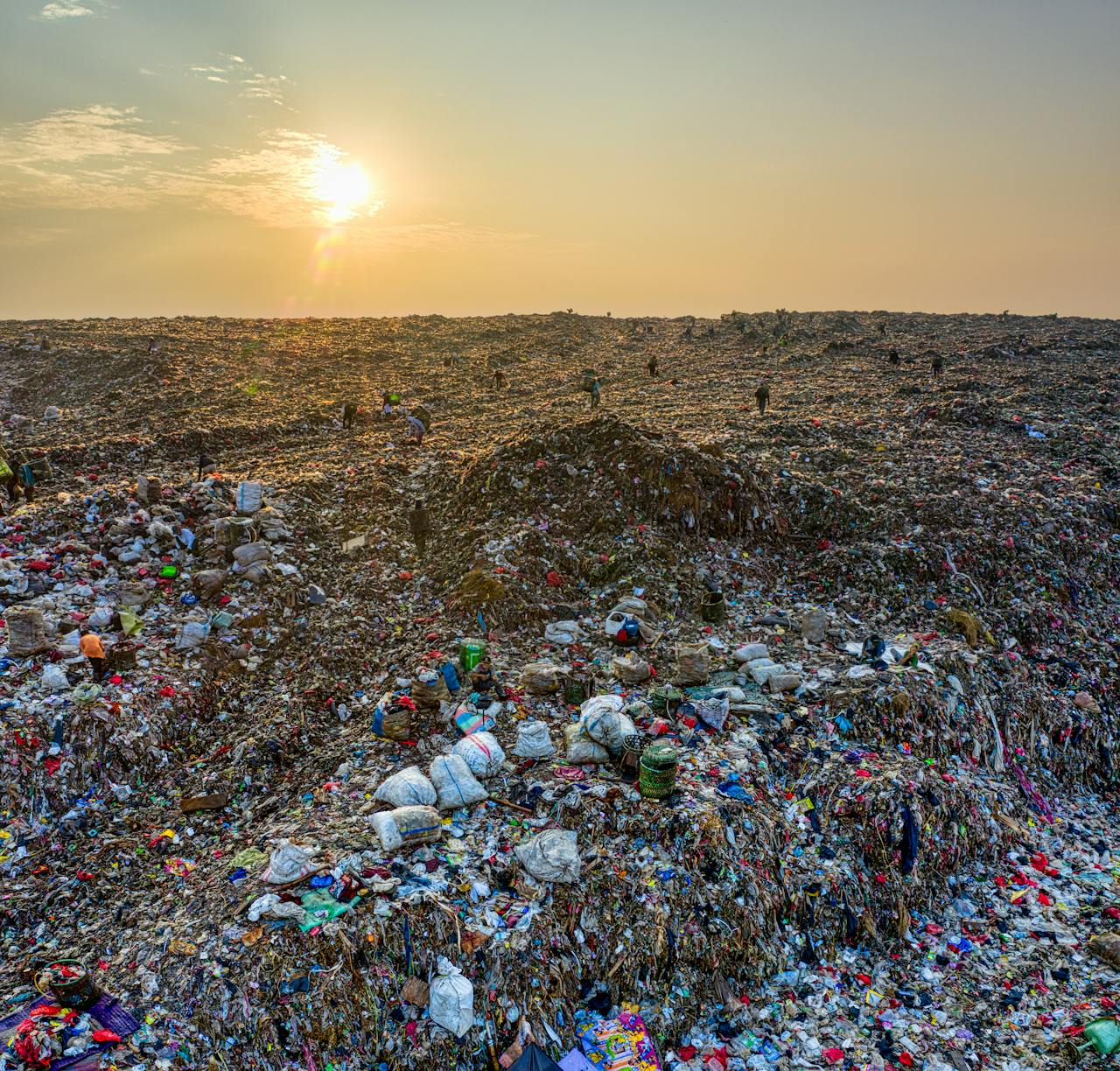 services-02 A wide view of a landfill at sunset in West Java, Indonesia, highlighting environmental issues.